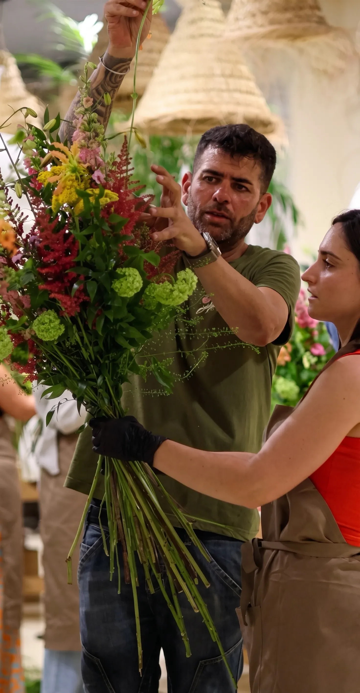 Maestro florista componiendo un ramo con flores frescas en el taller